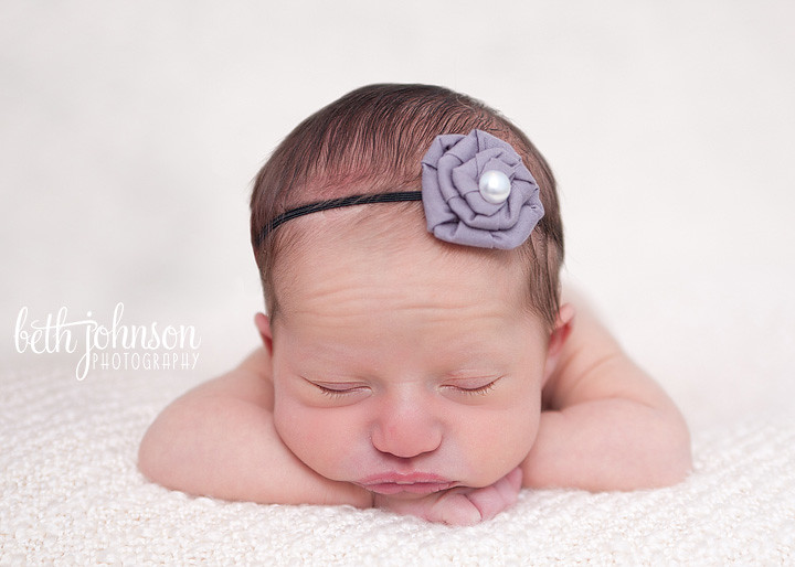 newborn baby girl with purple headband