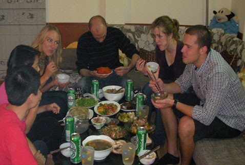 Foreign friends enjoying a traditional Tet meal with a Vietnamese family