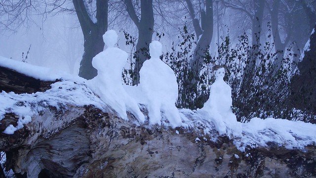 three snowmen by the canal