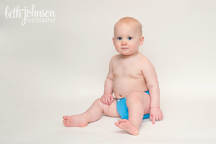 one year old boy in blue cloth diaper