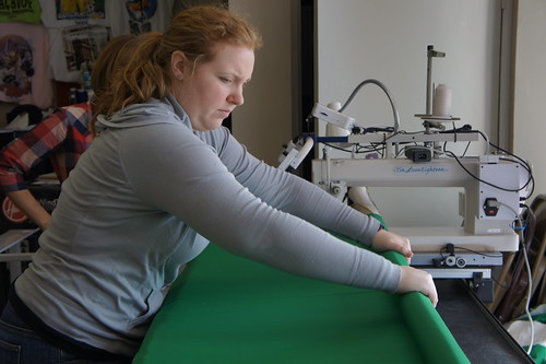Kaelin very seriously rolling and smoothing the fabric