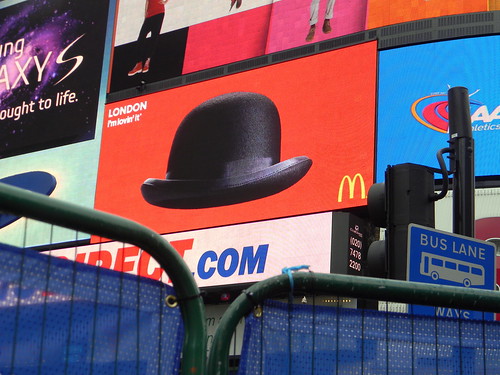 bowler hat MacDonalds advert behind fence eros piccadilly circus 1st February 2011 15:09.40pm