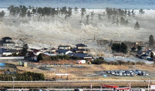 Waves of tsunami hit residences after a powerful earthquake in Natori, Miyagi prefecture (state), Japan, Friday, March 11, 2011.  The largest earthquake in Japan's recorded history slammed the eastern coast Friday. (AP Photo/Kyodo News) JAPAN OUT, MANDATO