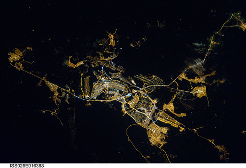 Brasilia, Brazil at Night (NASA, International Space Station, 01/08/11) <i>Editors Note: This is part of a larger Flickr set, &quot;NASA Views Earth at Night,&quot; located here: <a href="http://www.flickr.com/photos/28634332@N05/sets/72157625188331491/">www.flickr.com/photos/28634332@N05/sets/72157625188331491/</a> </i>  Brasilia, Brazil at night time is featured in this image photographed by an Expedition 26 crew member on the International Space Station. Whether seen at night or during the day, the capital city of Brazil is unmistakable from orbit. Brasilia is located on a plateau (the Planalto Central) in the west-central part of the country, and is widely considered to be one of the best examples of 20th century urban planning in the world. One of its most distinctive design features-as seen from above-suggests a bird, butterfly, or airplane traveling along a northwest-southeast direction, and is made dramatically visible by city light patterns (center left, directly to the west of Lake Paranoa). Following the establishment of Brasilia in the early 1960s informal settlements began to form around the original planned city. Ceilandia, located to the west of Brasilia, was one such informal settlement. In 1970 the settlement was formalized by the government and is now a satellite city of Brasilia with its own distinct urban identity. The developed areas of Brasilia and its satellite cities are clearly outlined by street grid and highway light patterns at night in this photograph taken from the space station. The large unlit region to the northwest of the city is the Brasilia National Park (lower left); other dark regions to the south and southwest contain agricultural fields and expanses of Cerrado tropical savanna.   Image credit: NASA   View original image/caption: <a href="http://spaceflight.nasa.gov/gallery/images/station/crew-26/html/iss026e016368.html" rel="nofollow">spaceflight.nasa.gov/gallery/images/station/crew-26/html/...</a>  More about space station research: <a href="http://www.nasa.gov/mission_pages/station/research/index.html" rel="nofollow">www.nasa.gov/mission_pages/station/research/index.html</a>  Theres a Flickr group about Space Station Research. Please feel welcome to join! <a href="http://www.flickr.com/groups/stationscience/">www.flickr.com/groups/stationscience/</a>