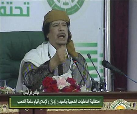 Muammar Gaddafi addresses the people's committees in Tripoli, Libya on the 34th anniversary of the establishment of the socialist system in this North African state. Gaddafi warned U.S. imperialism of a bloody war if it invaded the country. by Pan-African News Wire File Photos