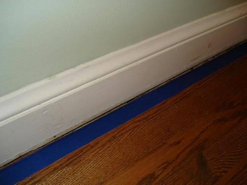 painters tape on edge of gap to protect floor