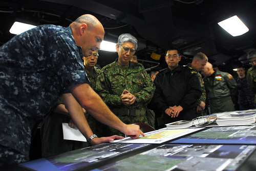 Navy admiral briefs relief efforts to Japanese general.