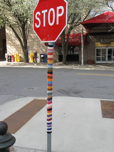 Yarnbombing a signpost in Berkeley