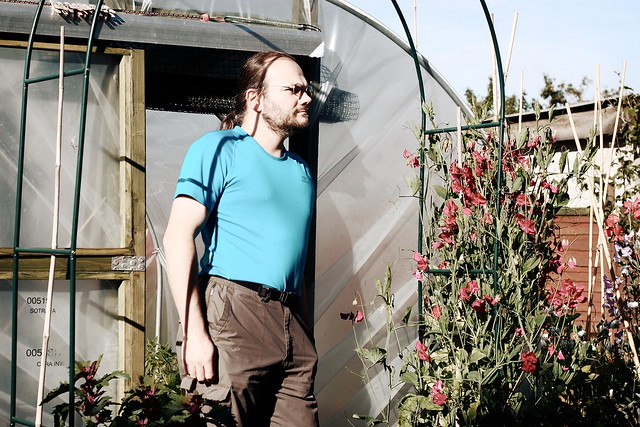Wulf, standing in front of the garden polytunnel