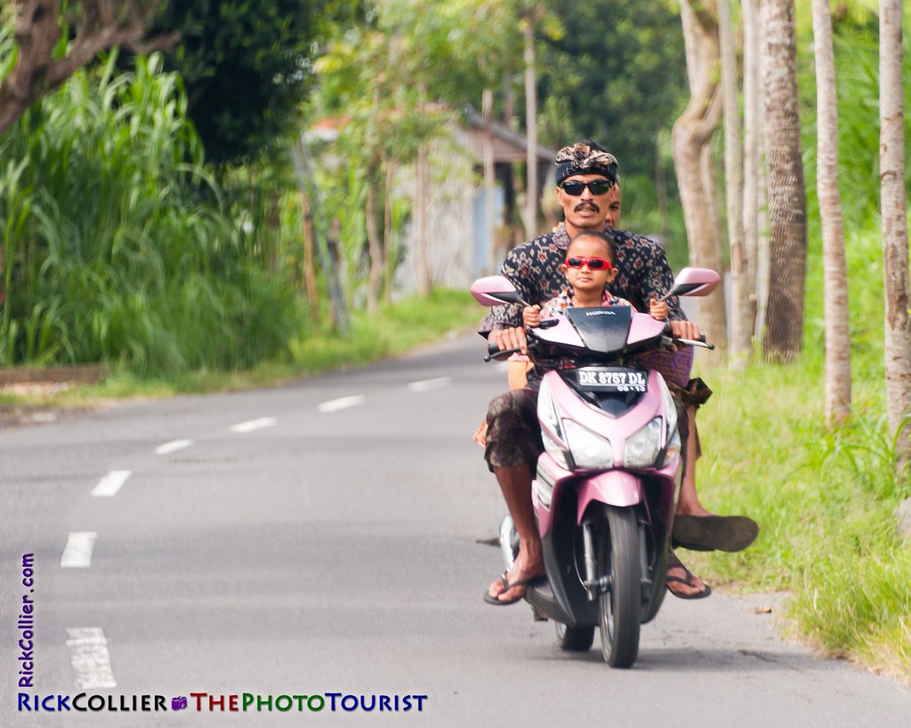 A family commutes from their temple, on the highway in Bali, Indonesia