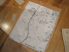 enlarged map sitting on a slab of wood