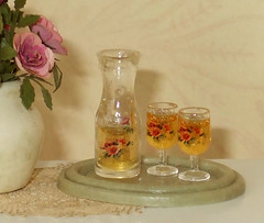 Wine carafe with glasses on green tray