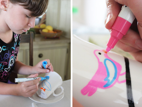 kid making art with markers on a cup