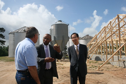 Foreign Agricultural Service Administrator John Brewer (center) meets with John Langdon (left), who is the owner of Langdon Farms in Johnston County, N.C., and South Korean Ambassador to the United States Han Duk-soo (far right) while touring the farm Tuesday. A visit to the farm, which raises pigs and cows among other agricultural goods, was one stop for Administrator Brewer, Ambassador Han and members of the U.S. Chamber of Commerce, while they were all in North Carolina this week promoting the benefits of the U.S.-Korea Trade Agreement, which is currently awaiting Congressional ratification. 