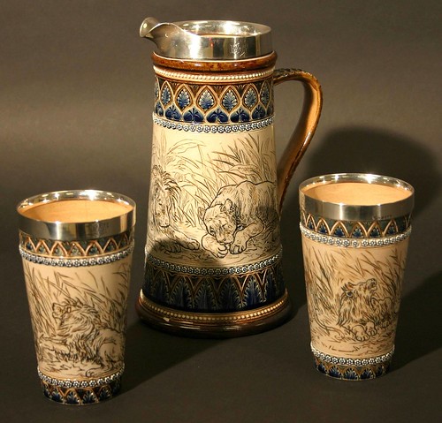 A jug and two beakers by Doulton Lambeth, decorated with pictures of lions by the renowned artist Hannah Barlow