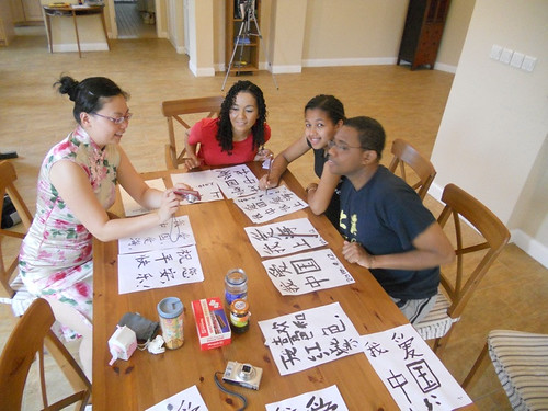 My family n their teacher writing Chinese characters