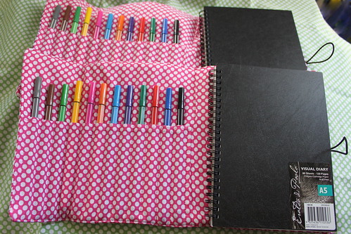 Notebook and pen roll holder open