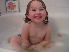 Speck grins in a bubble bath
