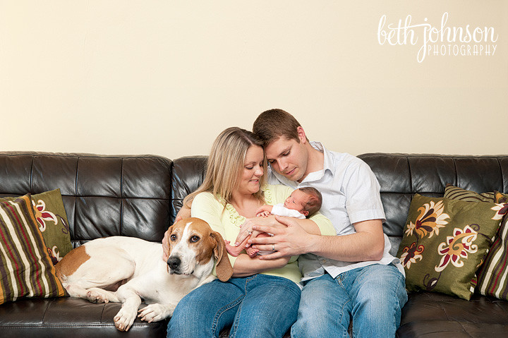 newborn baby girl with parents and dog