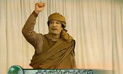 Libyan leader of the Revolution Muammar Gaddafi speaks on national television. Gaddafi has denied reports that he has left the country for Venezuela. by Pan-African News Wire File Photos
