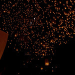 Sky lanterns float into the night