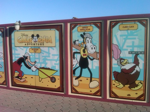 Temporary signs up in front of DCA featuring classic Disney characters
