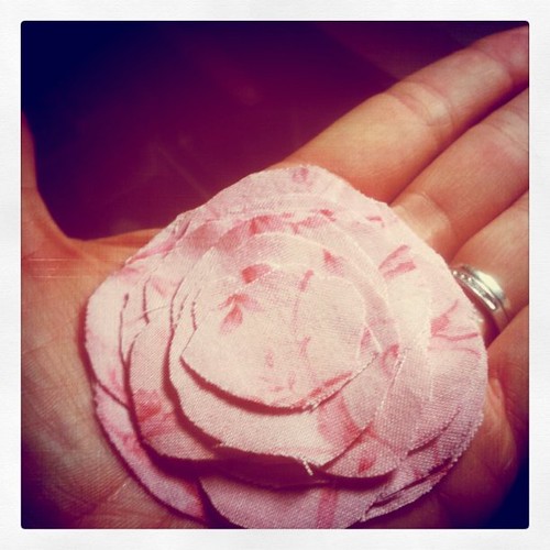 A fabric flower in the palm of my hand