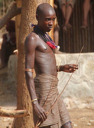 Man ready to beat the unmarried girls, Hamar Bull Jump, Ethiopia