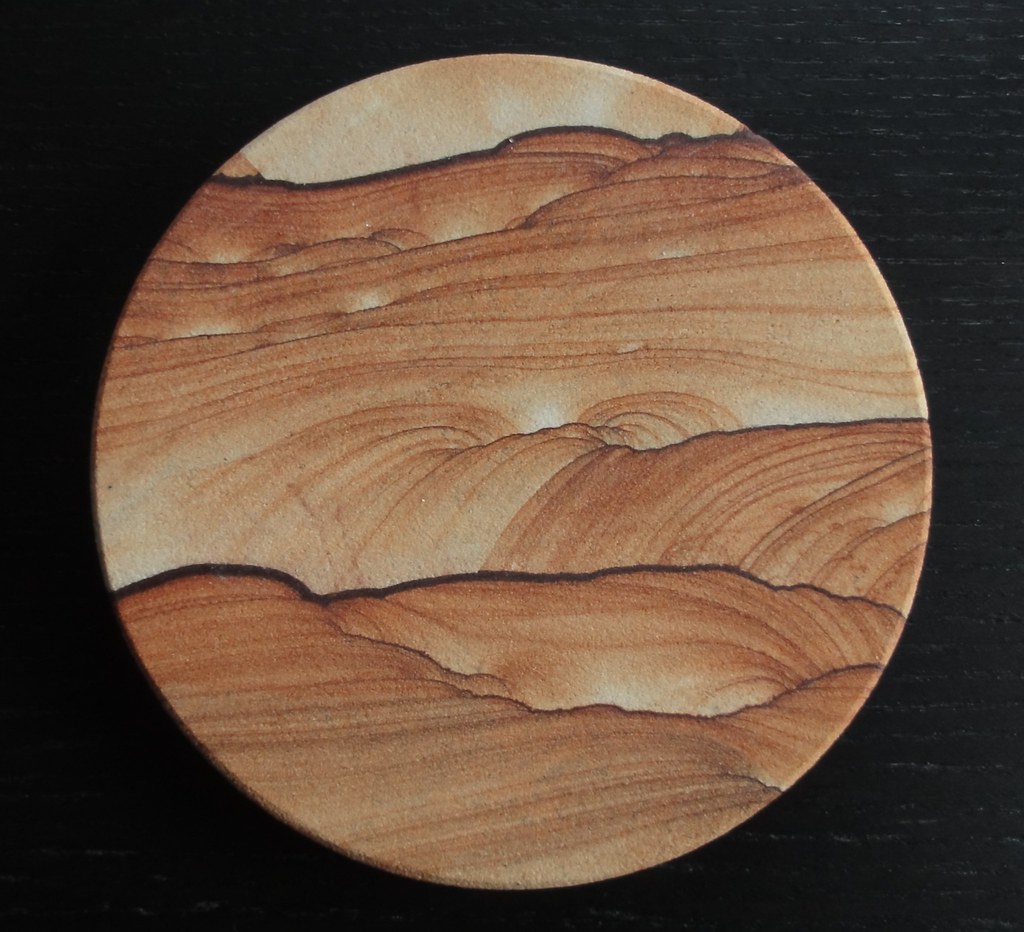 Image is similar to the coaster above, but the patterns are more like rolling desert dunes than mountains.