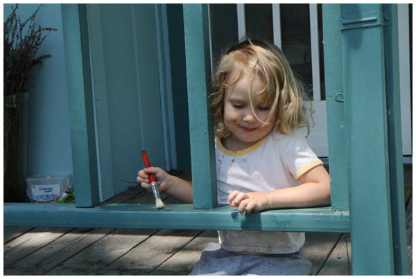 Before the toddler haircut (outside painting the railing of the porch with water)