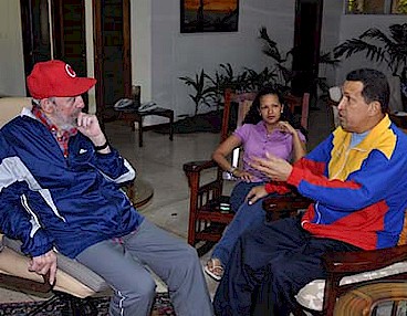 Former Cuban President Fidel Castro visits Venezuelan President Hugo Chavez while he is recuperating from surgery in Cuba. The woman sitting between them is unidentified. by Pan-African News Wire File Photos