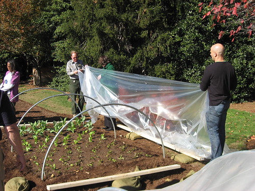 White House Assistant Chef Sam Kass and Agriculture Deputy Secretary Kathleen Merrigan prepare hoop houses at the White House Garden