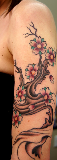 cross with angel wing tattoos. cherry blossom tree tattoo designs joss stone