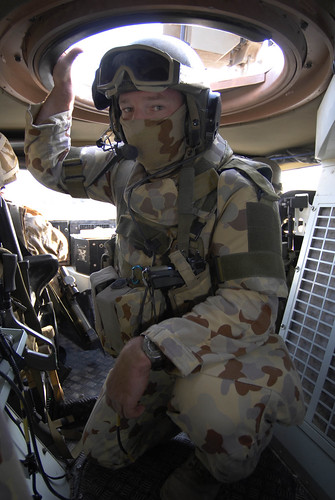 Corporal Anthony Anderson, an Infantry Mobility Vehicle driver from the 6th Battalion of The Royal Australian Regiment (6 RAR), checks his passengers are