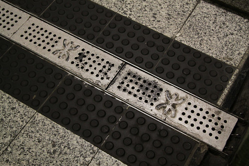 MTR logo on drain gratings: no use pinching them to reuse at home...