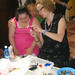 American artist working with Down Syndrome students on jewelry making techniques.