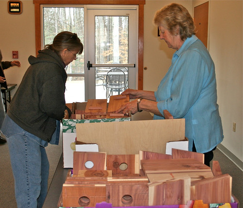 Volunteers organize bluebird box kits.