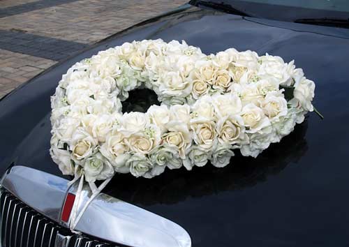 Wedding car decorated with a beautiful flower with a white rose which was