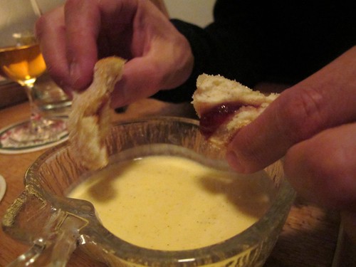 A pot of custard or as the French say "creme Anglaise" with doughnuts