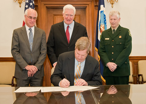 Agriculture Secretary Tom Vilsack signs the centennial of the "Week's Act Proclamation." Behind Secretary Vilsack from the left are: Harris Sherman, Undersecretary, National Resources and Environment, Congressman Jim Moran, Virginia and Tom Tidwell, Chief, National Forest Service. The event took place at the U.S. Department of Agriculture in Washington, D.C., on Wednesday, March 2, 2011. The "Week's Act Proclamation" named for Representative John Weeks of Massachusetts became law March 1, 1911 and ranks among the significant natural resource conservation achievements of the 20th Century which led to the creation of the National Forests throughout the east and additions of national forests and grasslands across the United States and Puerto Rico. USDA Photo by Bob Nichols.