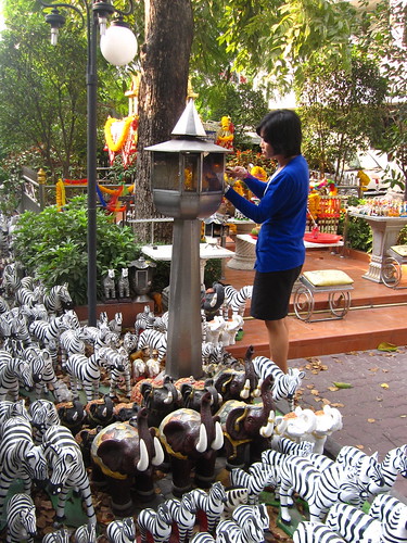 Small shrine surrouned by hundreds of plastic zebras, Bangkok