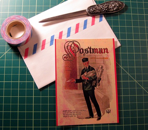 Postman postcard on desk