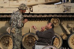 30 January: A man in a wheelchair talks to a soldier