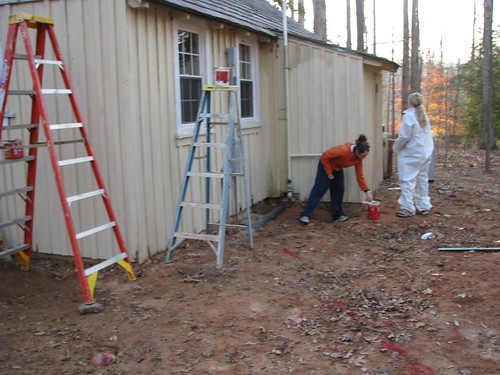 Volunteers give a Civilian Conservation Corps cabin a new coat of paint.