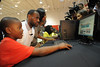 LeBron James and SAVANNAH BRINSON with Boys & Girls Club of Miami-Dade member interacting with new HP computer