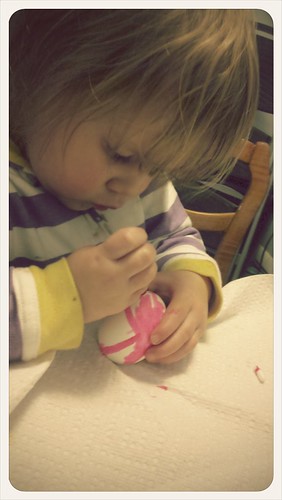 Cute little lady painting an egg!