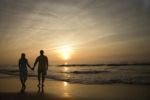 couple holding hands in sunset. at sunset holding hands.