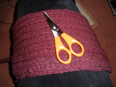 Cutting up old clothes to crochet a bag