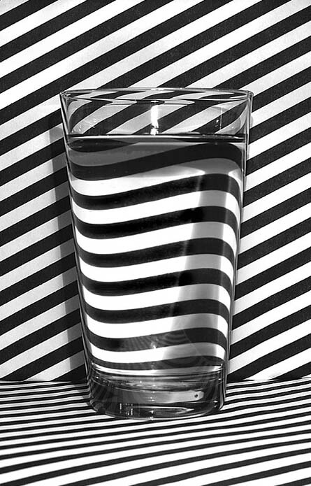 glass-of-water-on-black-and-white-striped-background