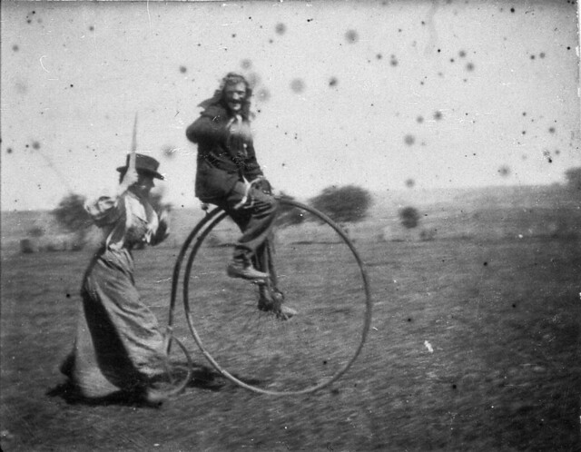 Man on a penny-farthing bicycle being chased by his sister (Maggie & Bob Spiers) - West Wyalong, NSW, C. 1900